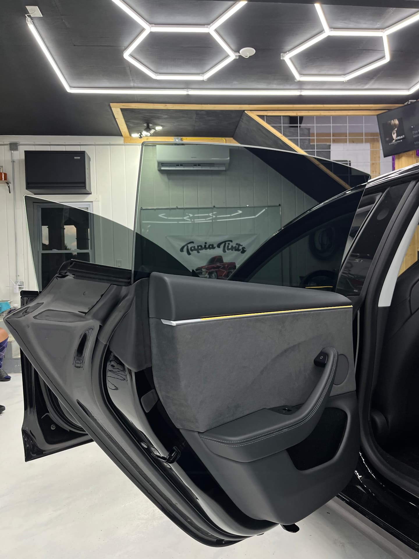 Ceramic window tint film installed on a Tesla Model 3 door glass