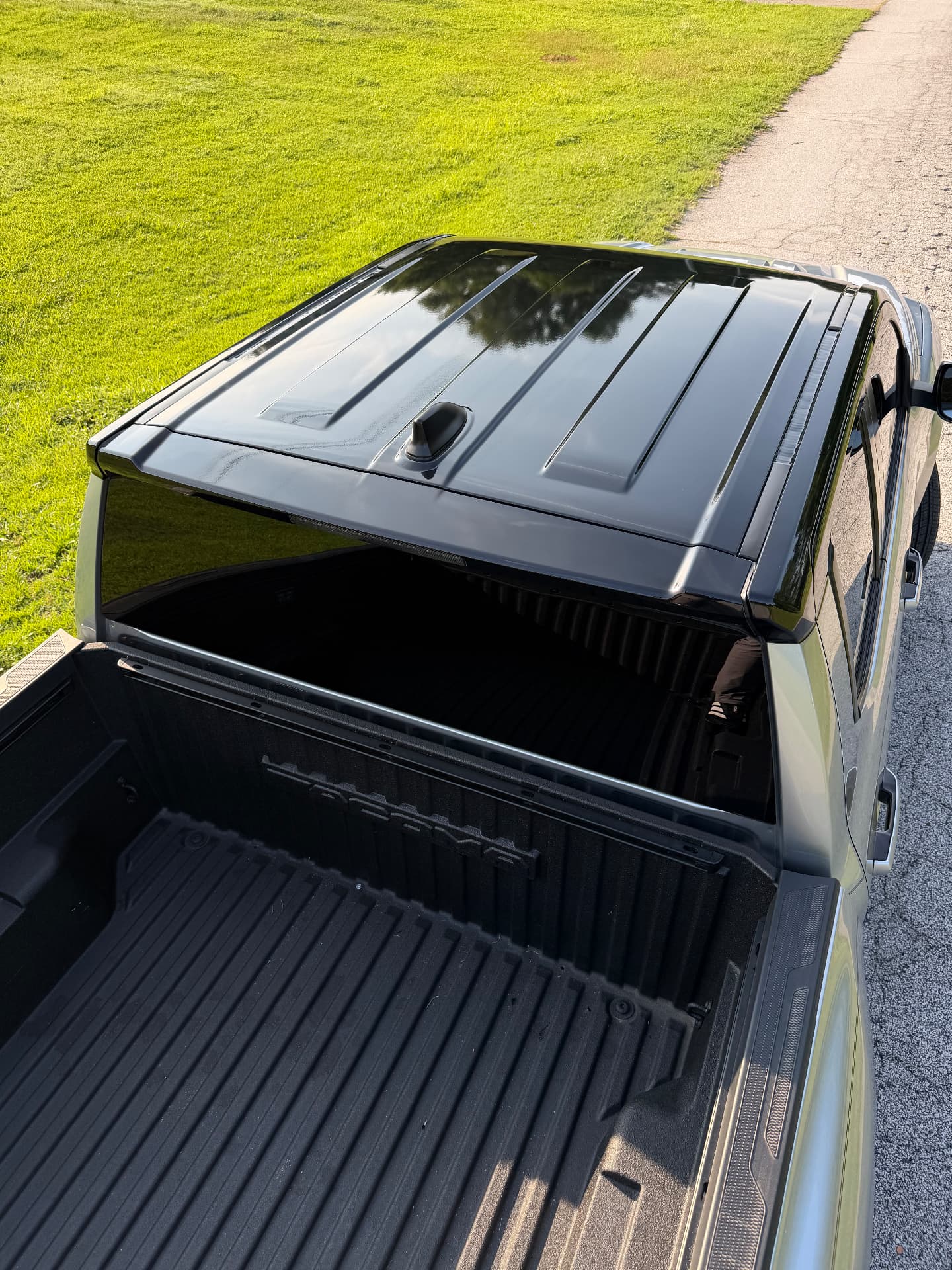 Gloss black wrapped tonneau cover and roof on a pickup truck by THSpecialists
